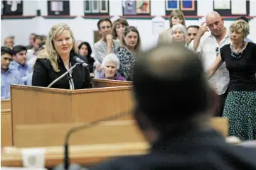  ?? PHOTOS BY LUIS SÁNCHEZ SATURNO/THE NEW MEXICAN ?? Kristin Carmichael, director of community engagement for the Southwest CARE Center, speaks in support of the gross receipts tax increase at Tuesday’s County Commission meeting. The commission­ers unanimousl­y approved an eighth-of-a-cent increase to fund...