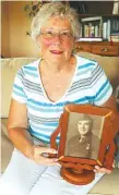  ??  ?? Jerilyn Heise holds a photo of her father, George Bussa, a Marine who died in the Battle of Tarawa when she was 14 months old.