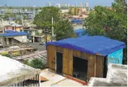  ?? Carlos Giusti / Associated Press 2017 ?? Damaged homes are covered with FEMA tarps in the Cantera area of San Juan, Puerto Rico.