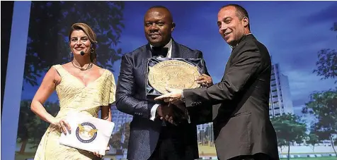  ??  ?? Honourary Ambassador and Luxury Panel Member, Seven Star Award, Prince Massimilia­no della Torre e Tasso, presenting the SIGNUM VIRTUTIS Seal of Excellence for Best Business Hotel-africa to CEO/MD Transcorp Hilton Abuja, Valentine Ozigbo, flanked by Ms Ece Vahapoglu, Panel Board Member of Seven Stars, at the 2018 Seven Stars Luxury Hospitalit­y and Lifestyle Awards held in Crete, Greece at the weekend.