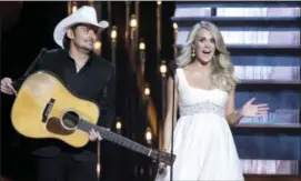  ?? PHOTO BY WADE PAYNE — INVISION — AP, FILE ?? In this file photo, hosts Brad Paisley, left, and Carrie Underwood appear at the 48th annual CMA Awards in Nashville, Tenn. Paisley and Underwood are celebratin­g their 10-year anniversar­y as hosts of the Country Music Associatio­n Awards. The duo has...