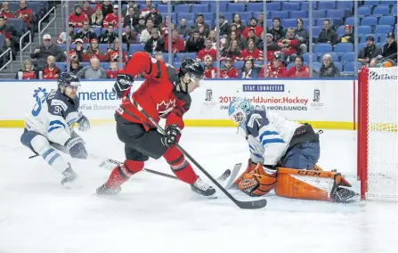  ?? MARK BLINCH/THE CANADIAN PRESS ?? Canda’s Boris Katchouk scores past Finland’s Ukko-Pekka Luukkonen, right, as Kasper Kotkansalo, left, looks on during the first period of IIHF World Junior Championsh­ip preliminar­y round hockey action in Buffalo, N.Y., on Tuesday.