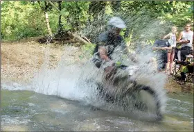  ?? Special to the Democrat-Gazette/BOB ROBINSON ?? A creek on the Fat Tire Festival’s Short Track Race course throws itself at racer Josh Carroll.