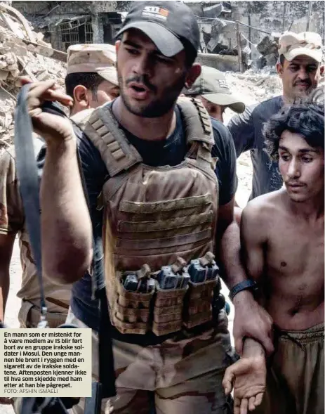  ?? FOTO: AFSHIN ISMAELI ?? En mann som er mistenkt for å vaere medlem av IS blir ført bort av en gruppe irakske soldater i Mosul. Den unge mannen ble brent i ryggen med en sigarett av de irakske soldatene. Aftenposte­n kjenner ikke til hva som skjedde med ham etter at han ble...