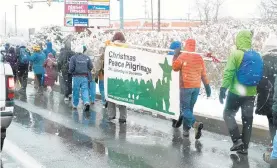  ?? MORNING CALL FILE PHOTO ?? People walk in a light snow for the annual Christmas Peace Pilgrimage from Nazareth to Bethlehem in 2017. This year’s event is Saturday.