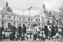  ?? Dan Kitwood / Getty Images ?? Hundreds of thousands of people fleeing Russia’s large-scale assault on Ukraine pass through Lviv on their way to Poland.