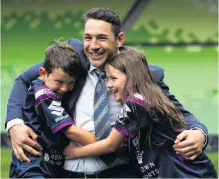  ?? PHOTO: GETTY IMAGES ?? Family ties . . . Melbourne Storm fullback Billy Slater embraces his children, Jake and Tyla Rose, after announcing his retirement at AAMI Park in Melbourne yesterday.