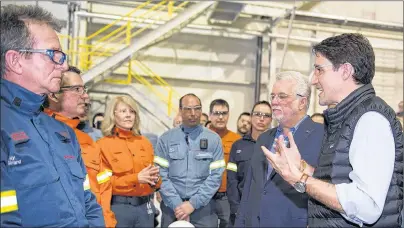  ?? CP PHOTO ?? Quebec Premier Philippe Couillard, left, looks on as Prime Minister Justin Trudeau speaks to workers and reporters at a news conference during a visit of the Rio Tinto AP60 aluminum plant Monday in Saguenay, Que.