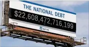  ?? GETTY IMAGES FOR PETERSON FOUNDATION DUANE PROKOP / ?? A national-debt billboard similar to this one in Cleveland has gone up in downtown Atlanta.