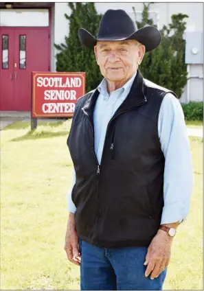  ?? STACI VANDAGRIFF/RIVER VALLY & OZARK EDITION ?? Doyle J. Scroggins, who will be 87 on Monday, is director of the Scotland Senior Community Center. After a tornado in April 2010 destroyed the original center, he and Judy Simmons spearheade­d a renovation project of the former Scotland Elementary School as a place for senior citizens. Scroggins, who owns two horses, also leads trail rides during the annual National Championsh­ip Chuckwagon Races in Clinton.