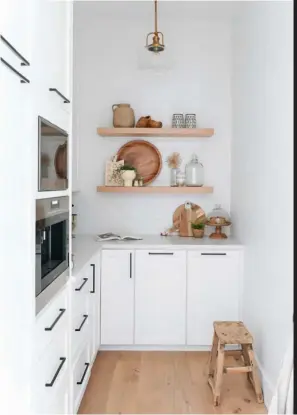  ??  ?? BELOW The adorable butler’s pantry is another new-build perk. “It’s my favourite spot in the kitchen,” says Jen. “There’s a coffee maker and lots of storage room.” The custom floating shelves were made from the same oak as the flooring. “I like having areas to style and display decorative items in a kitchen.”
PENDANT LIGHTS, Feiss Lighting. Aspen COUNTERTOP­S, Lido Quartz. SINK, Franke. FRIDGE, Sub-Zero. STOOLS, Structube. FAUCETS, POT FILLER, Delta. Cabinet HARDWARE, Marathon Hardware. SCONCES, Rejuvenati­on Lighting. BASKET, Indaba. EGG TRAY, two-tone POTTERY (holding utensils), Farmhouse Pottery. Pantry PENDANT LIGHT, Savoy House.