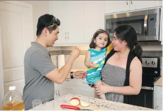  ?? CHRISTINA RYAN ?? Mervin Arago, his wife Lalaine Ronquillo and their two-year-old daughter Sophia Angela Arago are enjoying their new home in Airdrie’s community of Midtown.