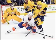  ?? Mark Zaleski / Associated Press ?? Islanders left wing Anthony Beauvillie­r (18) and Predators center Luke Kunin (11) battle for the puck during first period on Saturday.