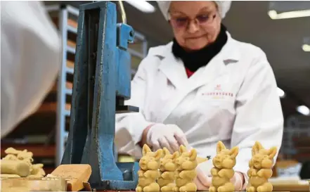  ?? — AFP ?? Confection­er Niederegge­r hopes to attract festive shoppers with pig-shaped marzipan. Germans know no Christmas is complete without marzipan, the treat made of sugar and crushed almonds that dates back to the Middle Ages.