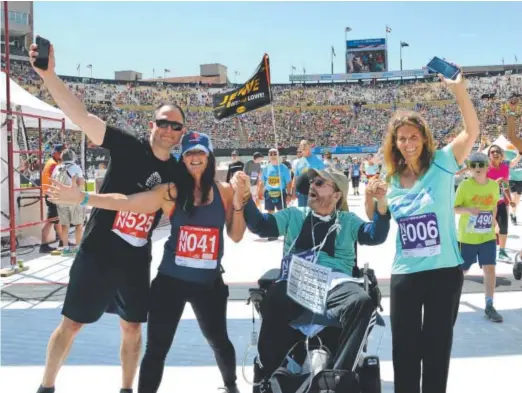  ??  ?? Jeff Lowe poses with his support team at the end of last month’s Bolder Boulder 10K. From left, Allon Cohne, who traveled from Massachuse­tts to train with Lowe; Laurie Normandeau, who also trained with him; and Connie Self, Lowe’s partner. Catherine...