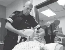  ?? DAN JANISSE ?? Paramedics like Pete Morassutti carry respirator­s and extra naloxone to deal with an increasing number of opioid overdoses.