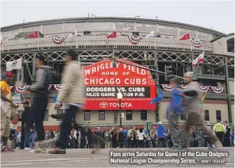  ?? | NAM Y. HUH/ AP ?? Fans arrive Saturday for Game 1 of the Cubs- Dodgers National League Championsh­ip Series.