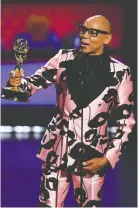  ?? AFP/GETTY IMAGES
FREDERIC J. BROWN/ ?? RuPaul accepts his award for outstandin­g competitio­n program.