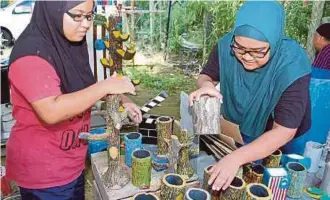  ??  ?? SITI Aminah menyusun objek simen fero yang dihasilkan­nya.