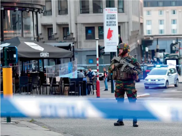  ?? — AFP ?? A soldier cordons off an area outside Gare Central in Brussels on June 20, 2017, after an explosion in the Belgian capital. The attacker, a Daesh sympathise­r, was shot and killed by the police.