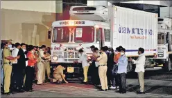 ?? REUTERS ?? A police officer performs prayers in front of a truck carrying the first consignmen­t of Covid, at the Serum Institute of India.