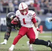  ?? ASSOCIATED PRESS FILE PHOTO ?? Nebraska wide receiver Wan’Dale Robinson (1) is chased down by Purdue defensive tackle Anthony Watts (8) during the first half of an NCAA college football game in West Lafayette, Ind.