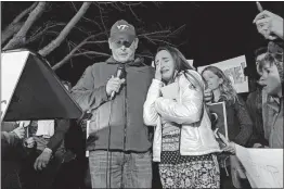  ?? [CLARENCE WILLIAMS/THE WASHINGTON POST] ?? Gillian Beard weeps while she is consoled by speaker Peter Reed, whose daughter was killed in the 2007 Virginia Tech shootings. They attended a vigil Friday night outside the National Rifle Associatio­n headquarte­rs in Fairfax, Va.