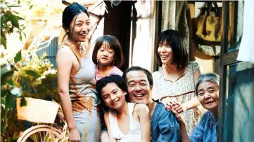  ??  ?? A ragtag family of petty thieves provides an affectiona­te home for an abused little girl in Kore-eda Hirokazu's family drama.