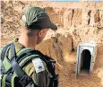  ??  ?? An Israeli soldier patrols the site of a tunnel built by Hamas from neighbouri­ng Gaza
