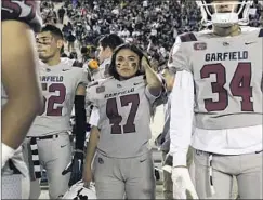  ?? Gabriella Angotti-Jones Los Angeles Times ?? DALIA HURTADO kicks for the Garfield High football team and plays four other sports to stay busy, but a deadly virus offers another challenge.