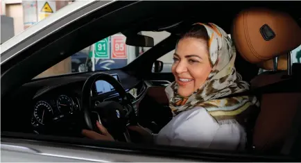  ?? (Zohra Bensemra/Reuters) ?? DR SAMIRA AL-GHAMDI, a practicing psychologi­st, drives her car in Jeddah, Saudi Arabia in June.