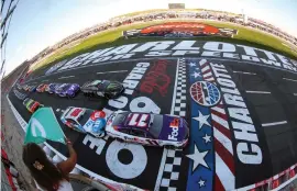 ?? (James Gilbert/Getty Images) ?? Denny Hamlin, driver of the #11 FedEx Ground Toyota, leads the field to the green flag to start the Cup Series Coca-Cola 600 at Charlotte Motor Speedway Sunday. After a wild double OT run, he’d be there for the checkered flag as well.
