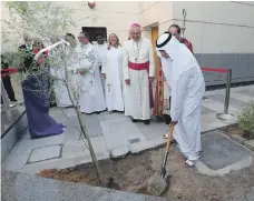  ?? Pawan Singh / The National ?? Sheikh Nahyan bin Mubarak, Minister of Tolerance, plants a ghaf tree on the 50th anniversar­y of St Andrew’s Church in Abu Dhabi in October