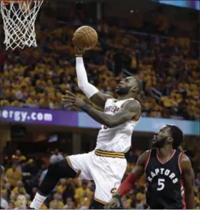  ?? TONY DEJAK —ASSOCIATED PRESS ?? LeBron James drives past the Raptors’ DeMarre Carroll in the first half in Game 1 of a second-round playoff series on May 1.