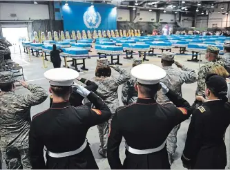  ?? JUNG YEON-JE
THE ASSOCIATED PRESS ?? U.S. soldiers salute during a repatriati­on ceremony for the remains of U.S. soldiers killed in the Korean War.