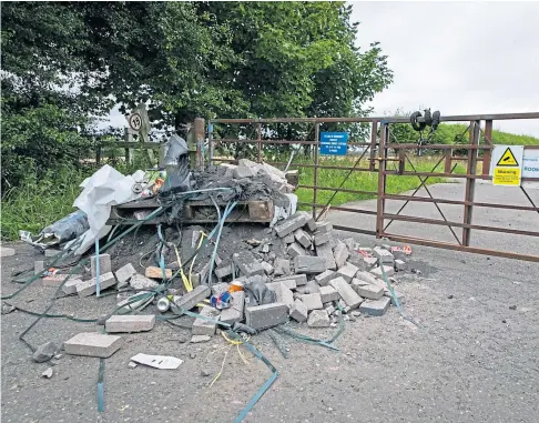  ?? Picture by Steve Brown. ?? “DISGRACE”: Fly-tippers have dumped a pile of rubble beside a gate at Little Raith wind farm.