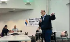  ?? COURTESY PATRICK LOHMANN/Source NM ?? Brian Colón, a lawyer for Singleton Schreiber and former state auditor, speaks to a group of clients at a Dec. 7 meeting in Las Vegas, New Mexico.