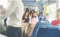  ?? (Ben Baruch) ?? COMMUTERS RIDING the Jerusalem light rail on Sunday after the order to wear masks indoors and in confined spaces was reinstated