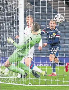  ??  ?? OFF THE MARK: Top: Che Adams fires in his first goal for Scotland to make it 3-0. Above: Ryan Fraser’s header makes it 4-0.