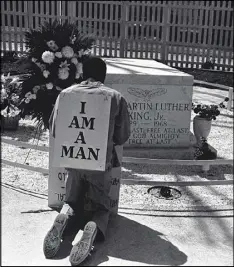  ?? AP ?? A striking Atlanta sanitation worker kneels at the grave of Dr. Martin Luther King Jr. after a rally by Southern Christian Leadership Conference supporting the strike in Atlanta on April 4, 1970. King was killed in Memphis, Tenn., while supporting a...