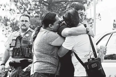  ?? CHRISTIAN MONTERROSA/AP ?? Bernadette and Joy Song Cuan hug their son Karl, a witness to the shooting Thursday morning at Saugus High School in Santa Clarita, California.