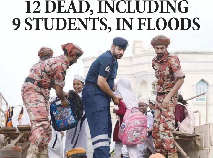  ?? ?? Students being rescued from a bus stuck in flood waters.