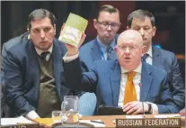  ?? AP PHOTO ?? Russian Ambassador to the United Nations Vassily Nebenzia holds up a copy of “Alice’s Adventures in Wonderland” as he speaks during a Security Council meeting on the situation between Britain and Russia Thursday.