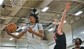  ?? KENNETH K. LAM/BALTIMORE SUN ?? Mount Saint Joseph’s Ace Valentine, left, drives past Archbishop Spalding’s David Hoyle to score in the first half of Thursday night’s MIAA A Conference semifinal.