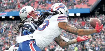  ?? TIM BRADBURY/GETTY IMAGES ?? Buffalo’s Kelvin Benjamin attempts to catch a touchdown pass as he is defended by New England’s Stephon Gilmore during the second quarter of a game at Gillette Stadium, on Sunday, in Foxboro, Mass. The touchdown was reversed after a review.