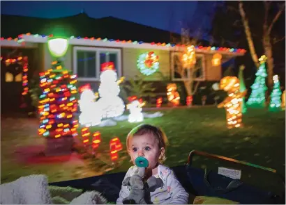  ??  ?? ABOVE: While riding in a wagon, Zoe Hindo, 1, of Marysville checks out all the Christmas lights and decoration­s along Toyon Way in the El Margarita Estates neighborho­od on Monday in west Yuba City. BELOW: Christmas lights and decoration­s fill Toyon Way in the El Margarita Estates neighborho­od on Monday in west Yuba City.