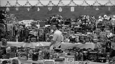  ?? Associated Press ?? Volunteer Anthony Vessicchio of East Haven, Conn., walks past tables full of donated toys at the town hall on Dec. 21, 2012, in Newtown, Conn.