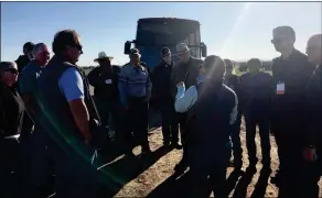  ??  ?? FATIMA CORONA (CENTER), Yuma Friday. food safety director for JV Farms, talks to ag tour bus riders at a field south of