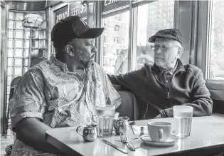  ?? NICOLE RIVELLI/EPIX VIA AP ?? Rob Robinson, left, with producer Norman Lear in a scene from the documentar­y, “America Divided.” The five-week docuseries premieres Friday at 9 p.m. on Epix.