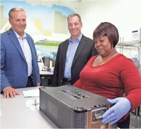  ??  ?? Titan Spine co-owner Kevin Gemas (left) and his business partner, Peter Ullrich Jr., watch Kathryn Johnikin inspect trade verificati­ons at the Mequon firm, which was founded in 2006.